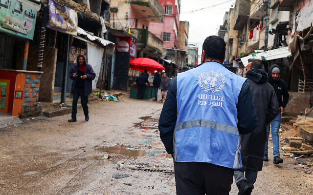UNRWA (United Nations Relief and Works Agency for Palestine Refugees) worker walking at the Balata refugee camp in the West Bank, February 4, 2024. (Photo by Jaafar Ashtiyeh/AFP)