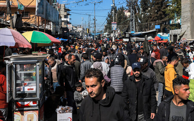 Palestinians walk along a crowded main street in Rafah in the southern Gaza Strip on February 8, 2024, amid the ongoing war between Israel and the Palestinian terror group Hamas. (Mohammed Abed/AFP)