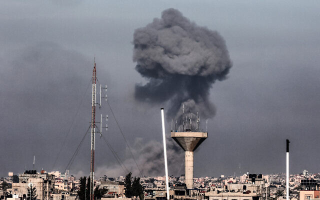 This picture taken from Rafah in the southern Gaza Strip, shows smoke rising over buildings in Khan Younis during Israeli bombardment on February 8, 2024, as fighting continues between Israel and the Palestinian terror group Hamas. (Mahmud Hams/AFP)