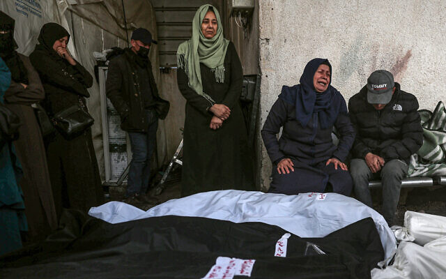Palestinians mourn after identifying the bodies of relatives killed in overnight Israeli strikes on the southern Gaza Strip, at Al-Najjar hospital in Rafah, on February 10, 2024. (Photo by SAID KHATIB / AFP)