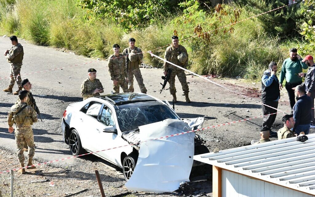 Lebanese army soldiers secure the area around a car wrecked in a reported Israeli drone strike in the village of Jadra between Beirut and the southern city of Sidon, on February 10, 2024. (AFP)