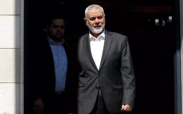 This handout picture provided by the Iranian foreign ministry on February 13, 2024, shows Hamas' political bureau chief Ismail Haniyeh preparing to welcome the Iranian Foreign Minister in Doha. (Iranian Foreign Ministry/AFP)