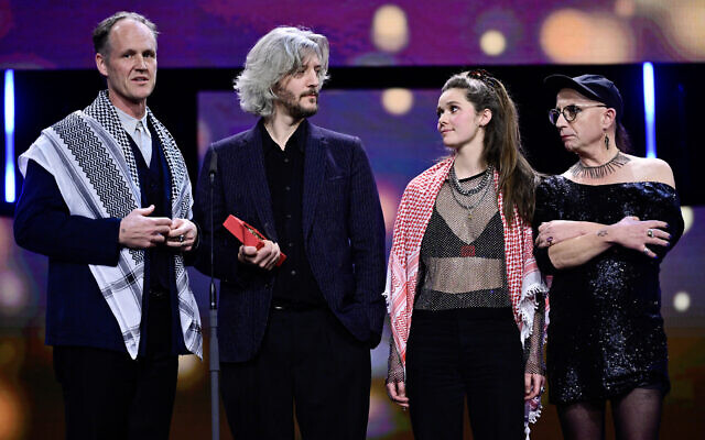 Filmmakers Ben Russell (L) and France's Guillaume Cailleau (2ndL) stand on stage while receiving the Encounters Award for Best Film for their film "Direct Action" during the awards ceremony of the 74th Berlinale International Film Festival, on February 24, 2024  in Berlin. (John MacDougall/AFP)