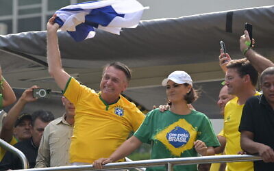 Former Brazilian President Jair Bolsonaro greets supporters while waving an Israeli flag during a rally in Sao Paulo, Brazil, Feb. 25, 2024. (Nelson Almeida/AFP)
