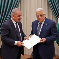 This handout picture provided by the Palestinian Authority's Press Office (PPO) shows PA Prime Minister Mohammad Shtayyeh (L) presenting the resignation of his government to Mahmoud Abbas, in Ramallah on February 26, 2024.  (Thaer GHANEM / PPO / AFP)