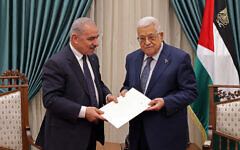This handout picture provided by the Palestinian Authority's Press Office (PPO) shows PA Prime Minister Mohammad Shtayyeh (L) presenting the resignation of his government to Mahmoud Abbas, in Ramallah on February 26, 2024.  (Thaer GHANEM / PPO / AFP)