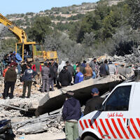 Residents and rescuers check the destruction after an overnight Israeli strike in the southern Lebanese village of Kafra, on February 29, 2024 (Photo by MAHMOUD ZAYYAT / AFP)