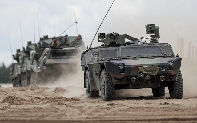 File: NATO military vehicles roll during a military exercising at the Training Range in Pabrade, some 60km (38 miles) north of the capital Vilnius, Lithuania on Monday, June 26, 2023. (AP Photo/Mindaugas Kulbis)
