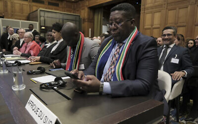Ambassador of the Republic of South Africa to the Netherlands Vusimuzi Madonsela checks his phone during a hearing at the International Court of Justice in The Hague, Netherlands, January 12, 2024. (Patrick Post/AP)