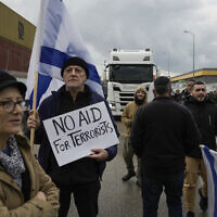 File - Protesters block the exit of Ashdod port to stop trucks they claim are carrying humanitarian aid destined for the Gaza Strip, in Ashdod, February 1, 2024. (AP Photo/Leo Correa)