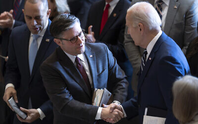 US President Joe Biden, shakes hands with House Speaker Mike Johnson, joined at left by House Minority Leader Hakeem Jeffries, at the conclusion of the National Prayer Breakfast, February 1, 2024, at the Capitol in Washington. (AP Photo/J. Scott Applewhite)