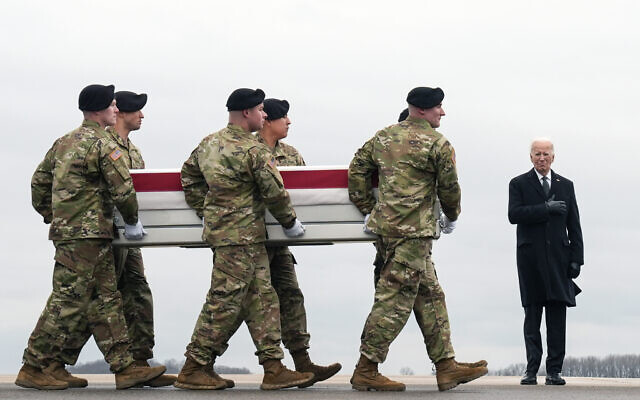 US President Joe Biden, right, stands as an Army carry team moves the transfer case containing the remains of US Army Sgt. Kennedy Ladon Sanders, 24, of Waycross, Ga., at Dover Air Force Base, Del., Friday, Feb. 2, 2024. Sanders was killed in a drone attack in Jordan on Jan. 28. (AP/Matt Rourke)