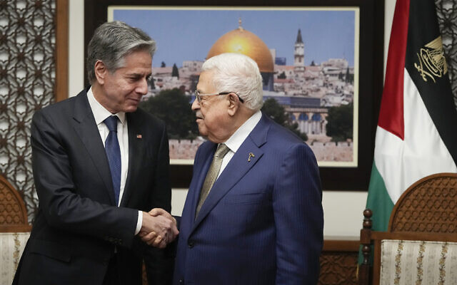 US Secretary of State Antony Blinken (left) and Palestinian Authority President Mahmoud Abbas shake hands during their meeting in the West Bank town of Ramallah, February 7, 2024. (Mark Schiefelbein/AP)