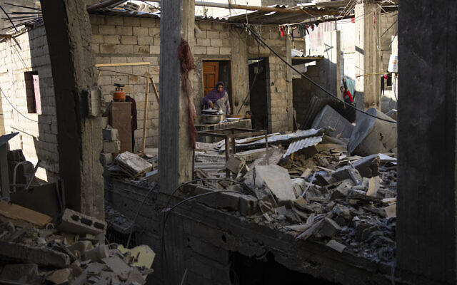 Palestinians look at the destruction after an Israeli strike in Rafah, southern Gaza Strip, February 8, 2024. (AP Photo/Fatima Shbair)