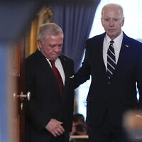 US President Joe Biden arrives with Jordan's King Abdullah II to speak in the Cross Hall of the White House, February 12, 2024, in Washington. (AP Photo/Andrew Harnik)