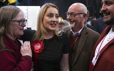 Labour Party candidate Gen Kitchen celebrates with her family after being declared winner in the Wellingborough byelection at the Kettering Leisure Village, Northamptonshire, Friday Feb. 16, 2024. (Joe Giddens/PA via AP)