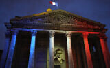 The portrait of Missak Manouchian is projected on the facade of the Pantheon monument in Paris, France, Feb. 21, 2024. (AP Photo/Michel Euler)