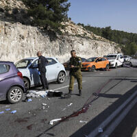 Police at the scene of a terror shooting attack outside of Ma'ale Adumim in the West Bank, February 22, 2024. (AP Photo/Mahmoud Illean)
