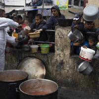 Palestinians line up for free food in Rafah, Gaza Strip, Feb. 23, 2024. (AP Photo/Fatima Shbair)
