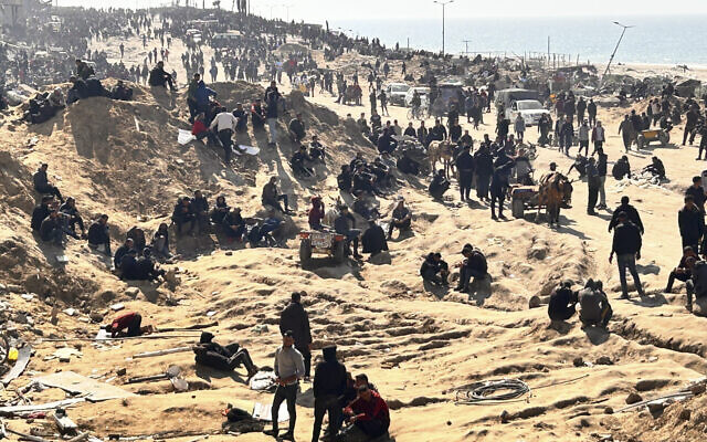 Palestinians wait for humanitarian aid on a beachfront in Gaza City, Gaza Strip, Sunday, February 25, 2024. (AP Photo/Mahmoud Essa)