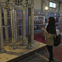 File: A student looks at Iran's domestically built centrifuges in an exhibition of the country's nuclear achievements, in Tehran, Iran, February 8, 2023. (AP Photo/Vahid Salemi)