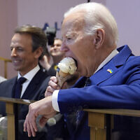 US President Joe Biden eats ice cream at Van Leeuwen Ice Cream, February 26, 2024, in New York, as Seth Meyers watches. (AP Photo/Evan Vucci)