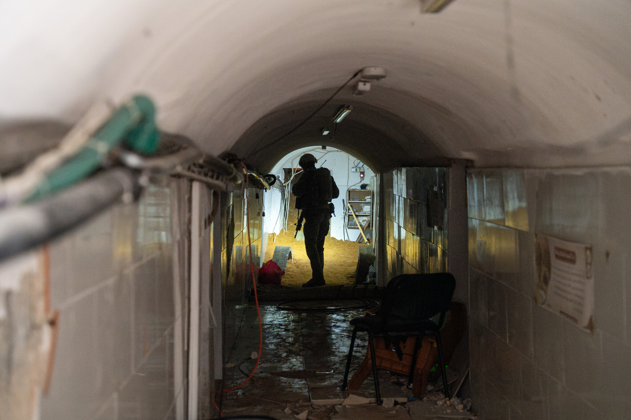 A soldier stands in a Hamas tunnel underneath an UNRWA school in Gaza City, February 8, 2024. (Emanuel Fabian/Times of Israel)