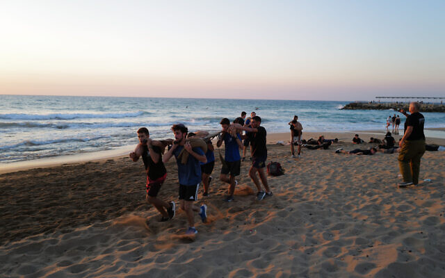 Israeli youth take part in pre-army preparatory program at the beach in Nahariya, September 8, 2022 (Michael Giladi/Flash90)