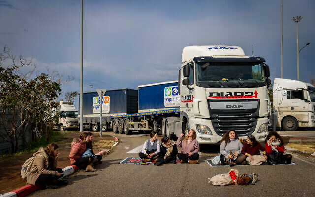 Activists for hostages block aid trucks from leaving the Ashdod Port during a protest against aid reaching the Gaza Strip, in Ashdod, February 1, 2024. (Chaim Goldberg/Flash90)