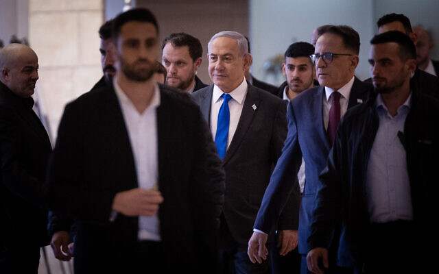 Prime Minister Benjamin Netanyahu, center, arrives for a Likud faction meeting at the Knesset on February 5, 2024. (Yonatan Sindel/Flash90)