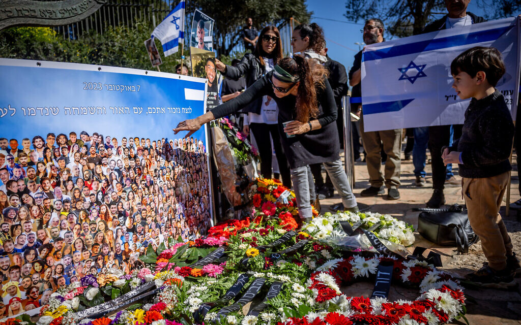 Families of Israelis who were murdered by Hamas terrorists at the Nova festival place pictures of their loved ones outside the Knesset in Jerusalem on February 7, 2024. (Yonatan Sindel/Flash90)