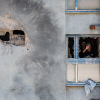 The damage after a rocket fired from Lebanon hit a building in the northern Israeli town of Kiryat Shmona, February 11, 2024. (David Cohen/Flash90)
