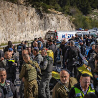 Israeli security and rescue forces at the scene of a terror shooting attack at a checkpoint near Ma'ale Adumim in the West Bank, February 22, 2024. (Chaim Goldberg/Flash90)