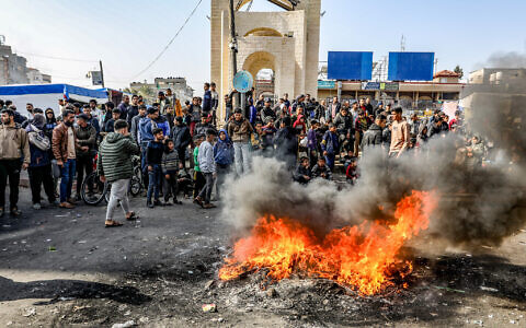 Palestinians burn tires during a protest in Rafah, in the southern Gaza Strip, on February 28, 2024 (Abed Rahim Khatib/Flash90)