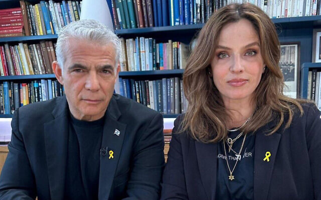 Yair Lapid (left) and Noa Tishby wearing the 3D-printed yellow ribbon pins created by industrial designer Shaul Cohen for the effort to release hostages held by Hamas. (Courtesy)