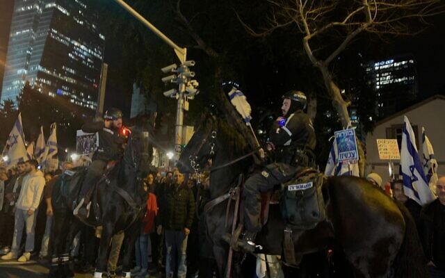 A mounted policeman attempts to clear protesters from the street at anti-government protest in Tel Aviv on February 10, 2024. (Charlie Summers/Times of Israel)