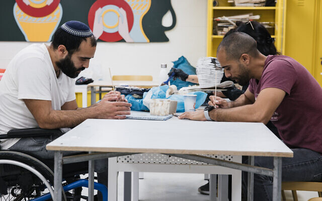 IDF veterans engaged in art activity at Beit Halochem in Tel Aviv, 2024. (Mark Nomdar)