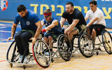 IDF veterans do warm-up exercise as part of wheelchair basketball training at Beit Halochem in Tel Aviv, 2024. (Mark Nomdar)