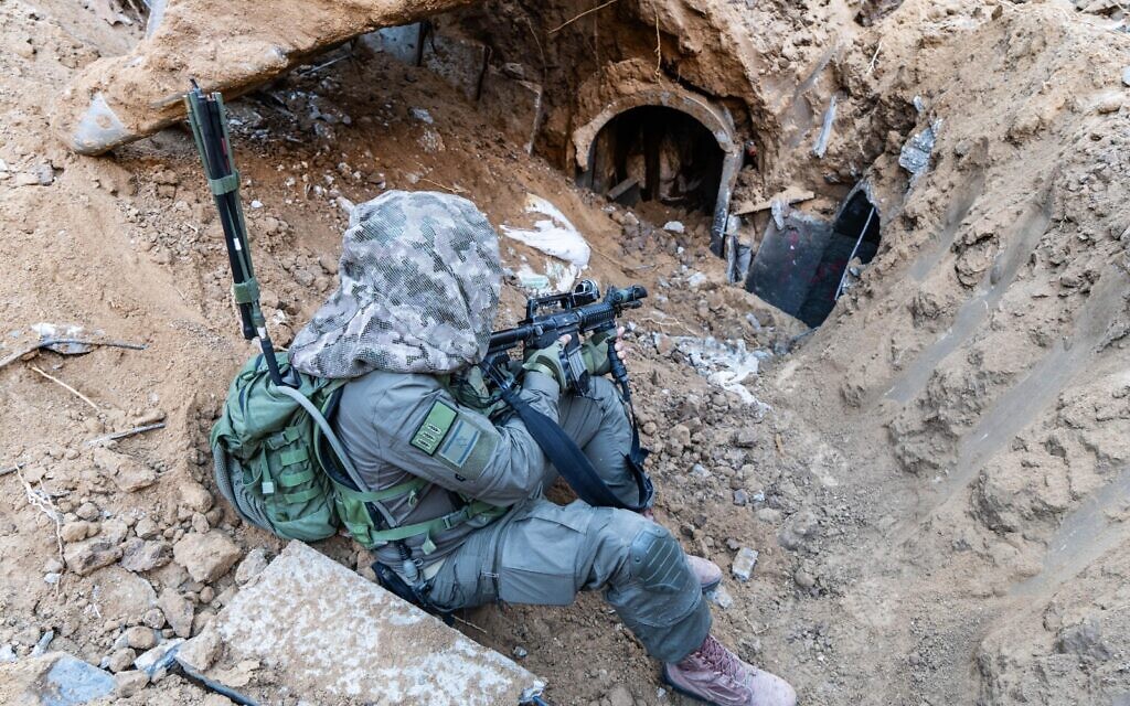 An officer of the 55th Reserve Paratroopers Brigade guards a tunnel entrance in southern Gaza's Khan Younis, in a handout image published February 1, 2024. (Israel Defense Forces)