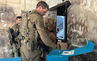 This handout photo released by the Israel Defense Forces on February 27, 2024, shows soldiers casting their municipal elections ballots at a polling site in the Gaza Strip, amid the war there against Hamas. (Israel Defense Forces)