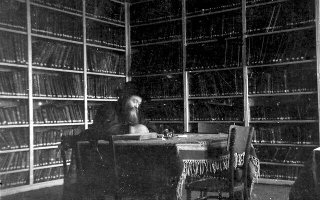 Rabbi Meir Shapiro sits in the library of the Chachmei Lublin Yeshiva in a photograph taken between the yeshiva's opening in 1930 and his death in 1933. The fate of the yeshiva's library under the Nazis is a subject of mystery. (Courtesy Grodzka Gate-NN Theater Center)