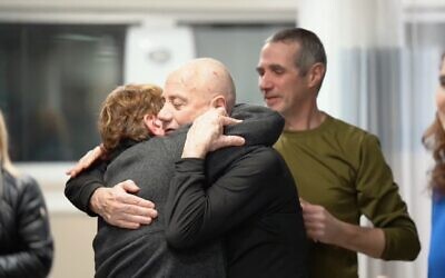 Louis Har (C) hugs a loved one as Fernando Marman looks on at Sheba Medical Center, February 12, 2024. (Screen grab)