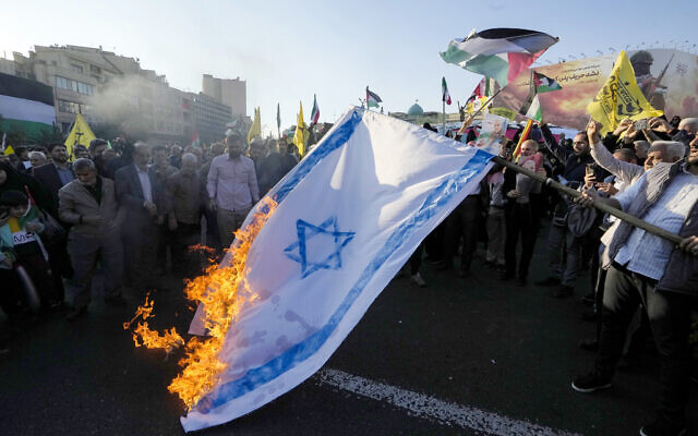 Iranians burn an Israeli flag during a protest in Tehran in support of Palestinians in Gaza on November 18, 2023 (Photo by AFP)