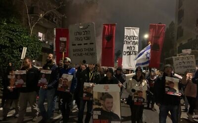 Protesters demanding a hostage deal march down Jerusalem's Azza Street to the prime minister's official residence on February 17, 2024. (Charlie Summers/Times of Israel)