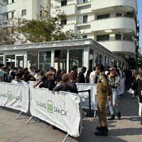 Customers line up at the opening of the first Israel branch of US fast-food burger chain Shake Shack in Tel Aviv on February 27, 2024. (Sharon Wrobel/Times of Israel)