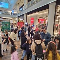 Israeli families enjoy a music headphone party at the TLV fashion mall in Tel Aviv during municipal election day on February 27, 2024. (Courtesy)