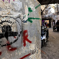 The logo of the Palestinian Islamic Jihad movement at the Shatila camp for Palestinian refugees in a southern suburb of Beirut on November 7, 2023. (Photo by AHMAD AL-RUBAYE / AFP)