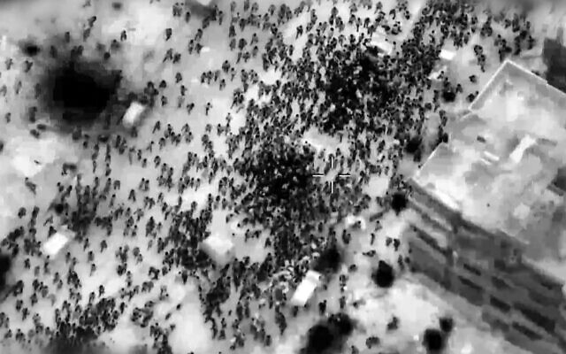 This image grab from a handout video released by the IDF on February 29, 2024, shows crowds rushing aid trucks in northern Gaza. (Aline Manoukian/Israel Defense Forces/AFP)
