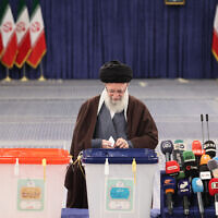 Iran's supreme leader Ayatollah Ali Khamenei casts his ballots during the parliamentary and key clerical body elections at a polling station in Tehran on March 1, 2024. (Atta Kenare/AFP)