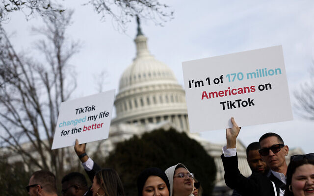 Participants hold signs in support of TikTok outside the US Capitol Building, in Washington, DC, on March 13, 2024. (Anna Moneymaker/Getty Images/AFP)